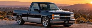 Black and silver 1990s OBS-style pickup at sunset. AI-generated editorial illustration.